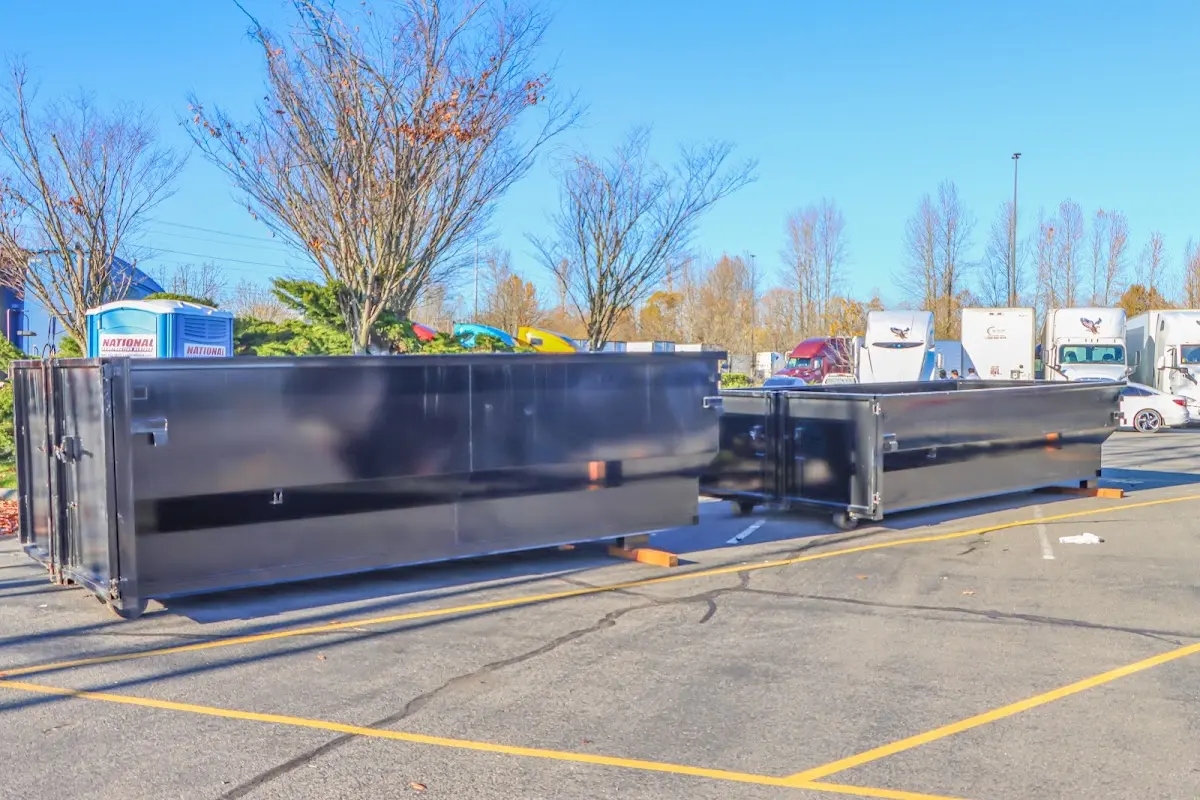 Professional dumpster rental service with roll-off container on residential driveway in Oak Park